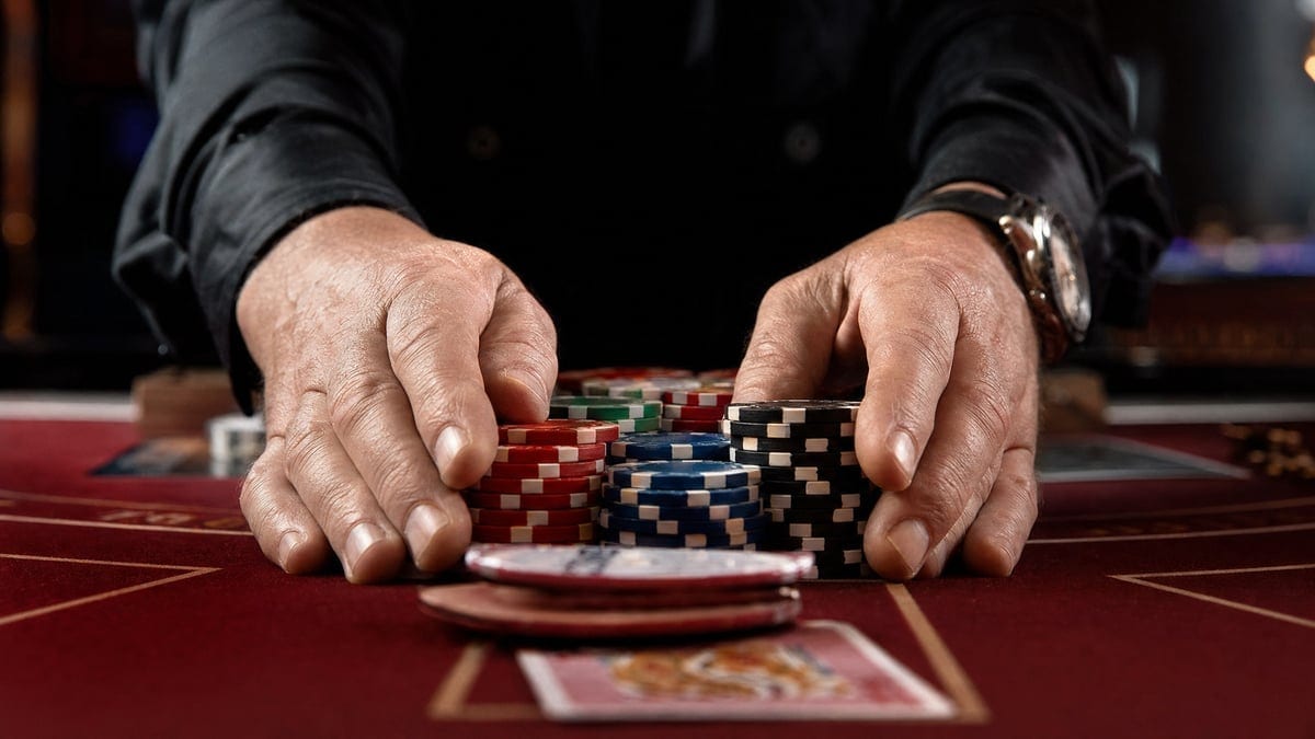 High stakes poker chips being pushed forward on table