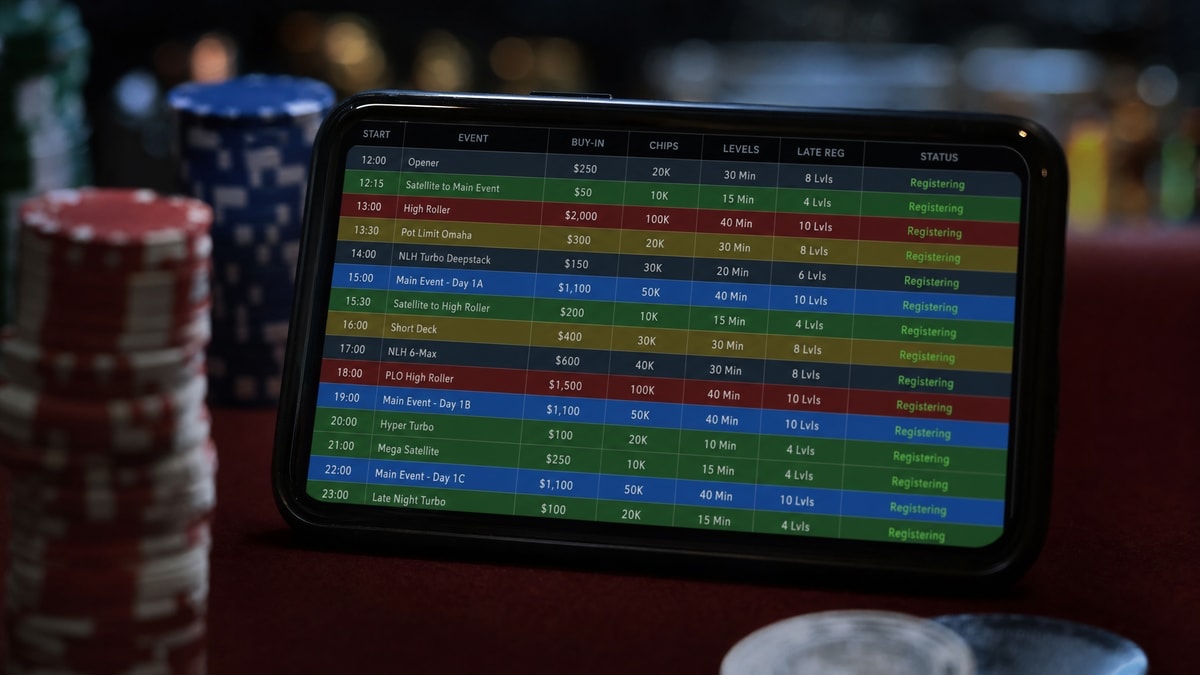 A mobile device displaying an online poker tournament schedule