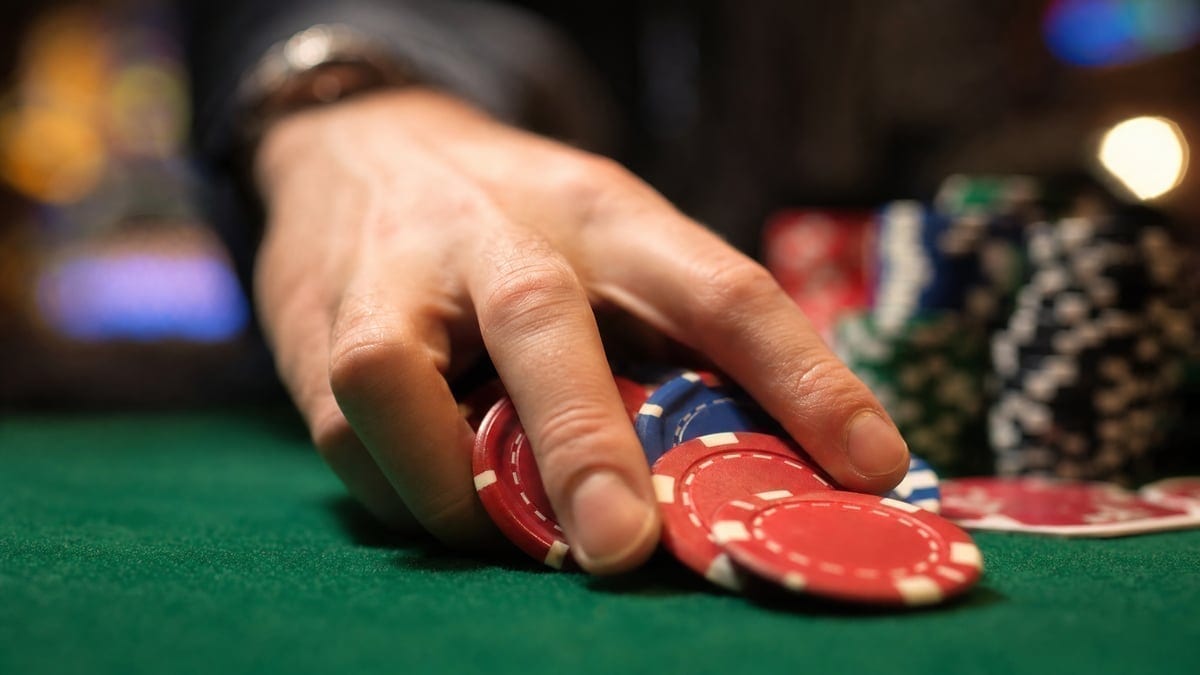 Poker chips being pushed across the table in a high stakes game