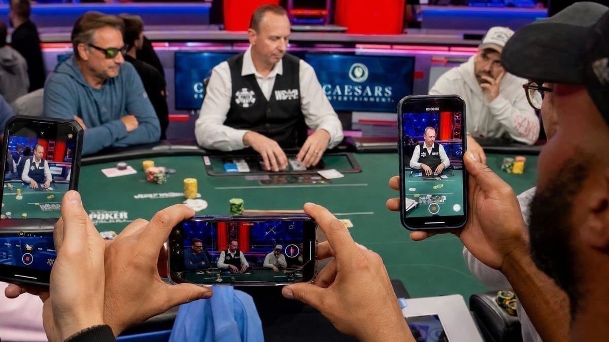 Content creators filming poker action at WSOP tables with smartphones