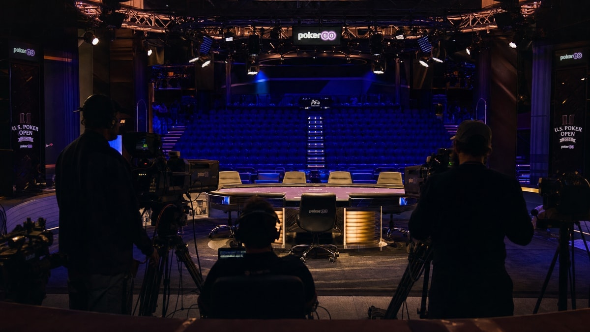 A televised poker broadcast set with cameras trained on a tournament table